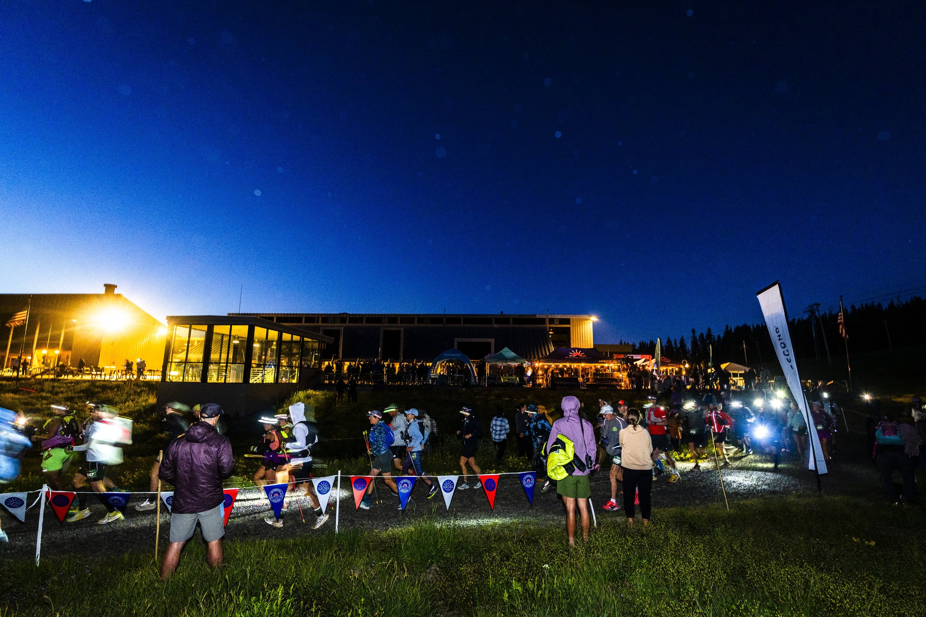 Runners gathering at a night trail race start