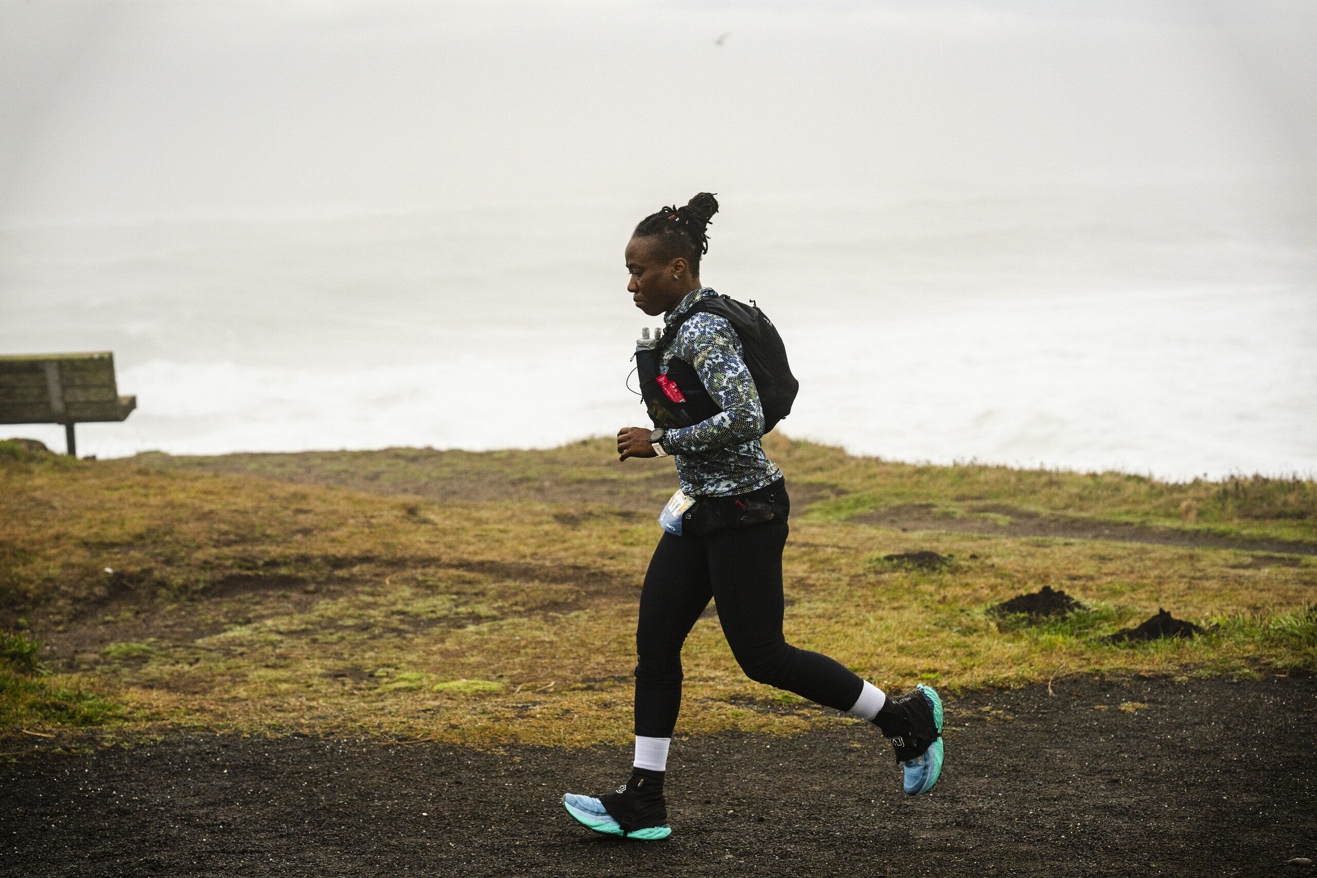 Runner of color moving through open trail terrain