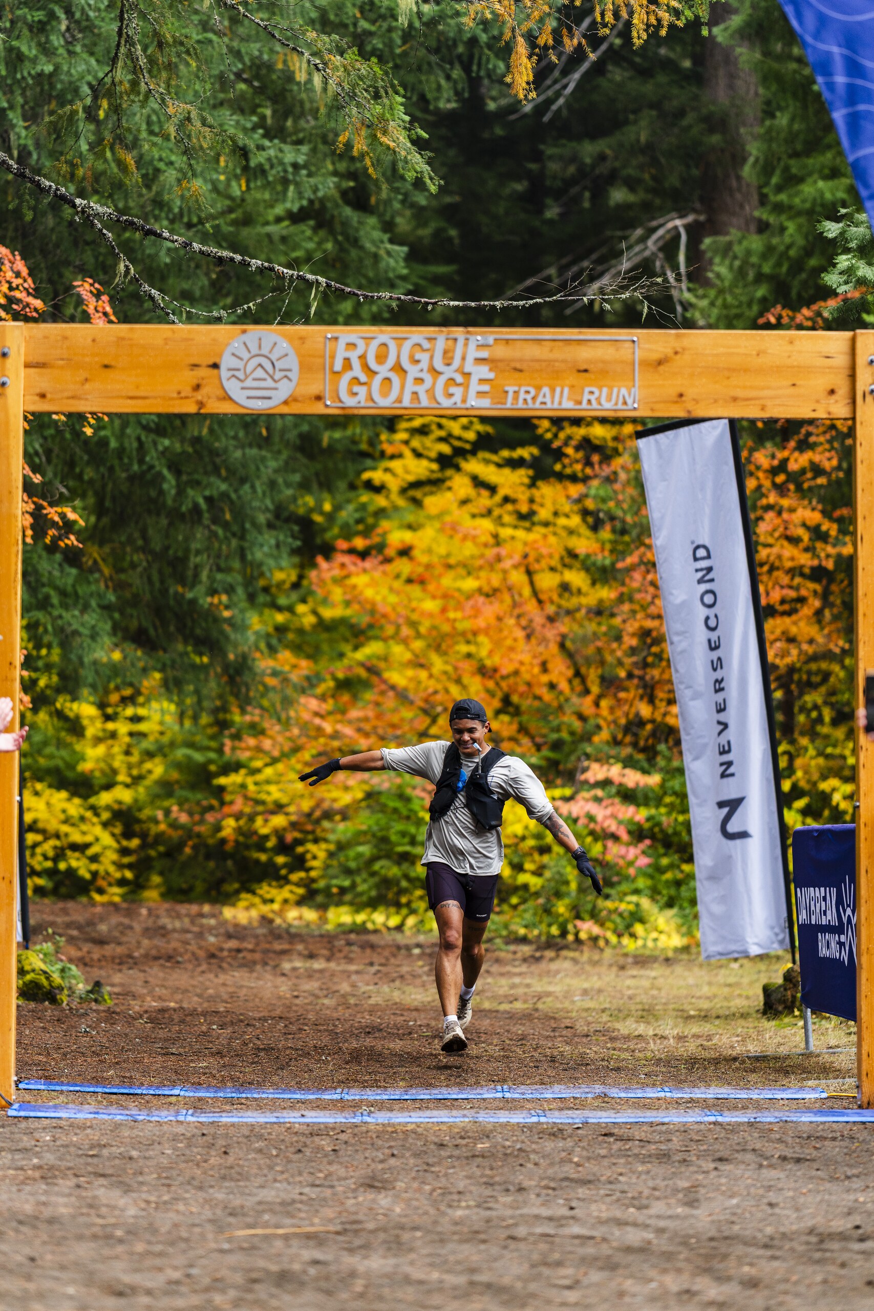 Runner crossing a trail race finish line